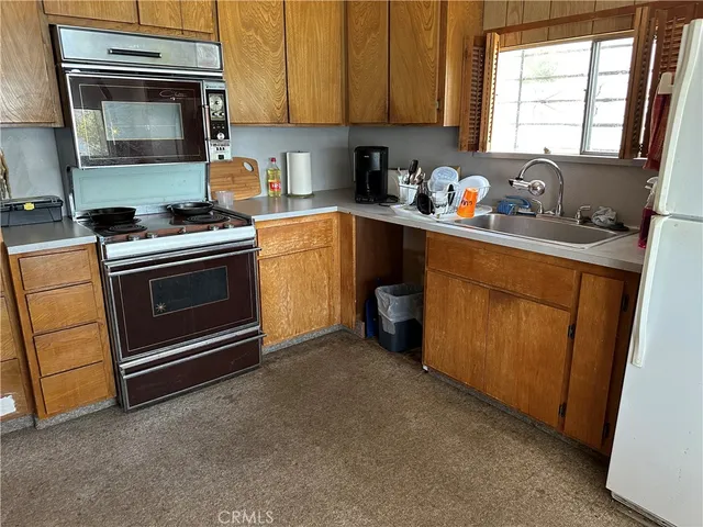 a bedroom with two beds and a chandelier