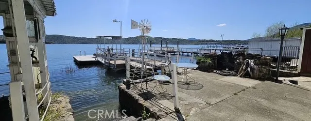 a roof deck view with table and chairs and wooden floor