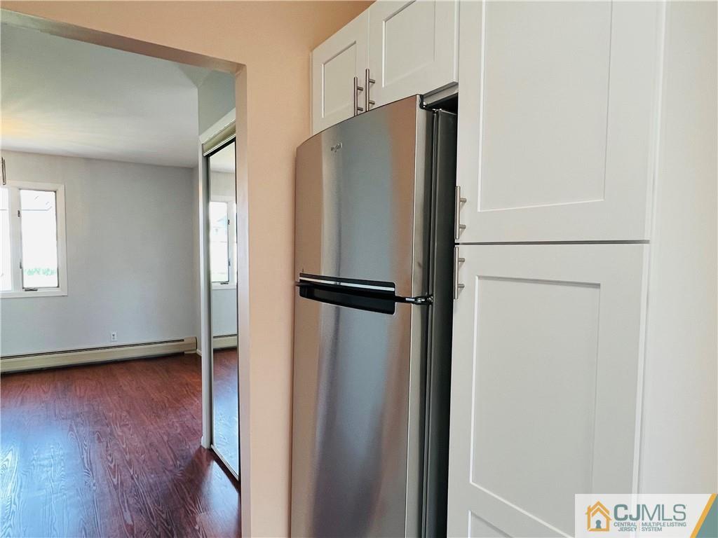 55 Glenville Road Edison, NJ 08817 - Photo 11 of 28 a view of a refrigerator in kitchen and wooden floor