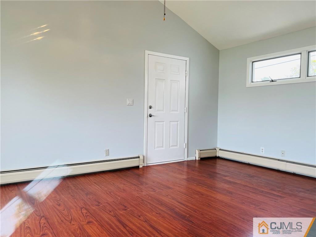 55 Glenville Road Edison, NJ 08817 - Photo 18 of 28 an empty room with wooden floor and windows