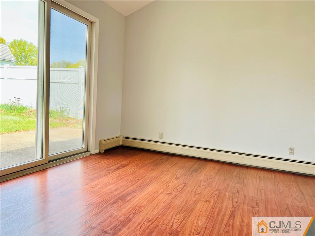 55 Glenville Road Edison, NJ 08817 - Photo 19 of 28 an empty room with wooden floor and windows