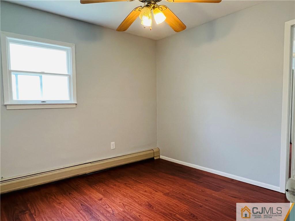 55 Glenville Road Edison, NJ 08817 - Photo 23 of 28 an empty room with wooden floor and windows