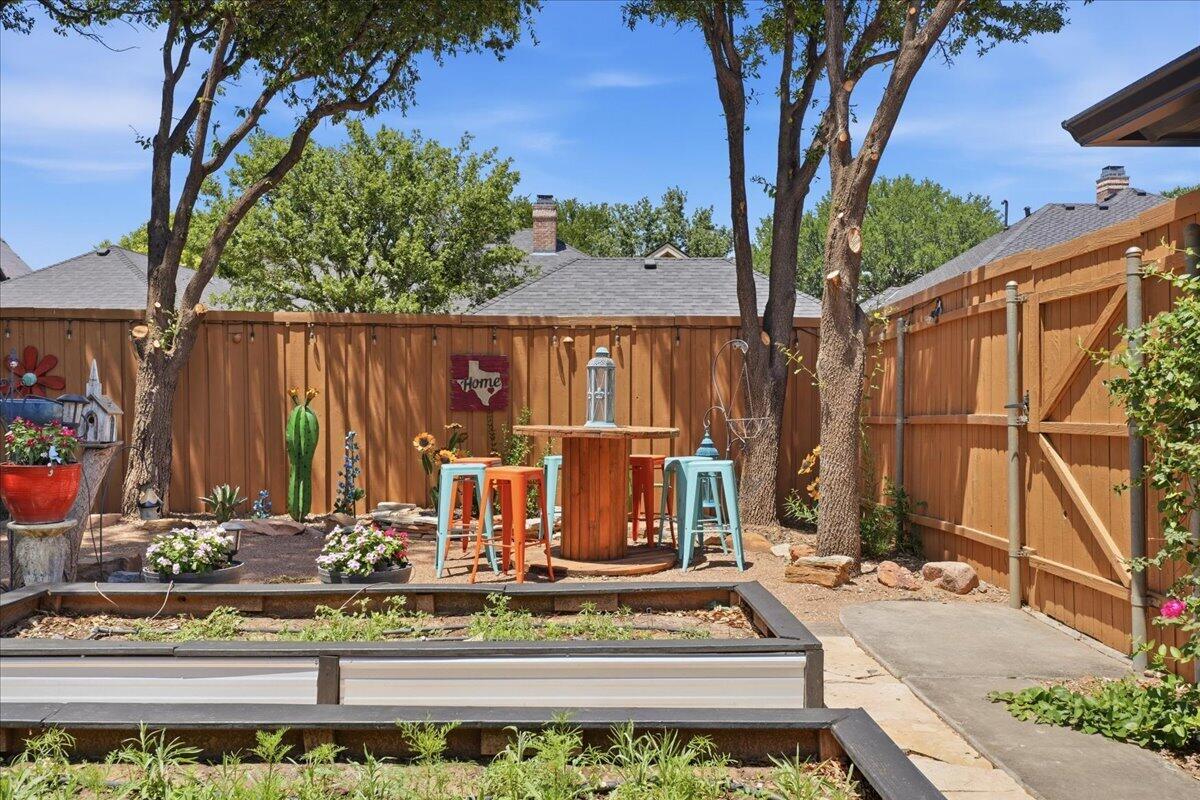 4612 100th Street Lubbock, TX 79424 - Photo 51 of 55 a view of a house with a yard and potted plants