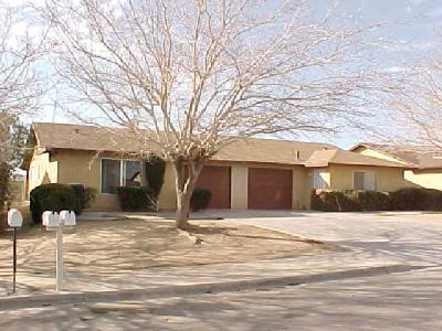 15838 Condor Road Victorville, CA 92394 - Photo 1 of 1 a front view of a house with a yard