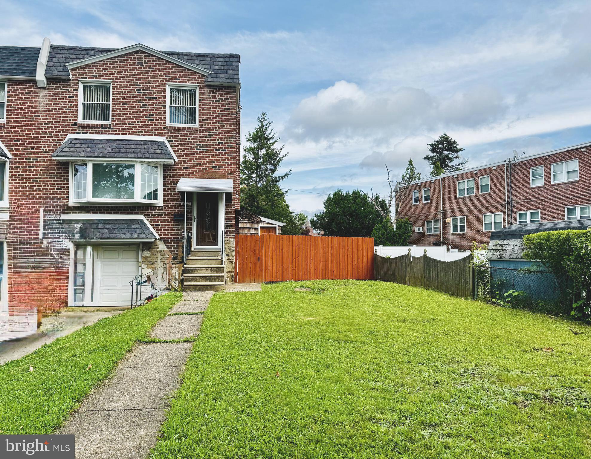 a front view of a house with yard and a garage