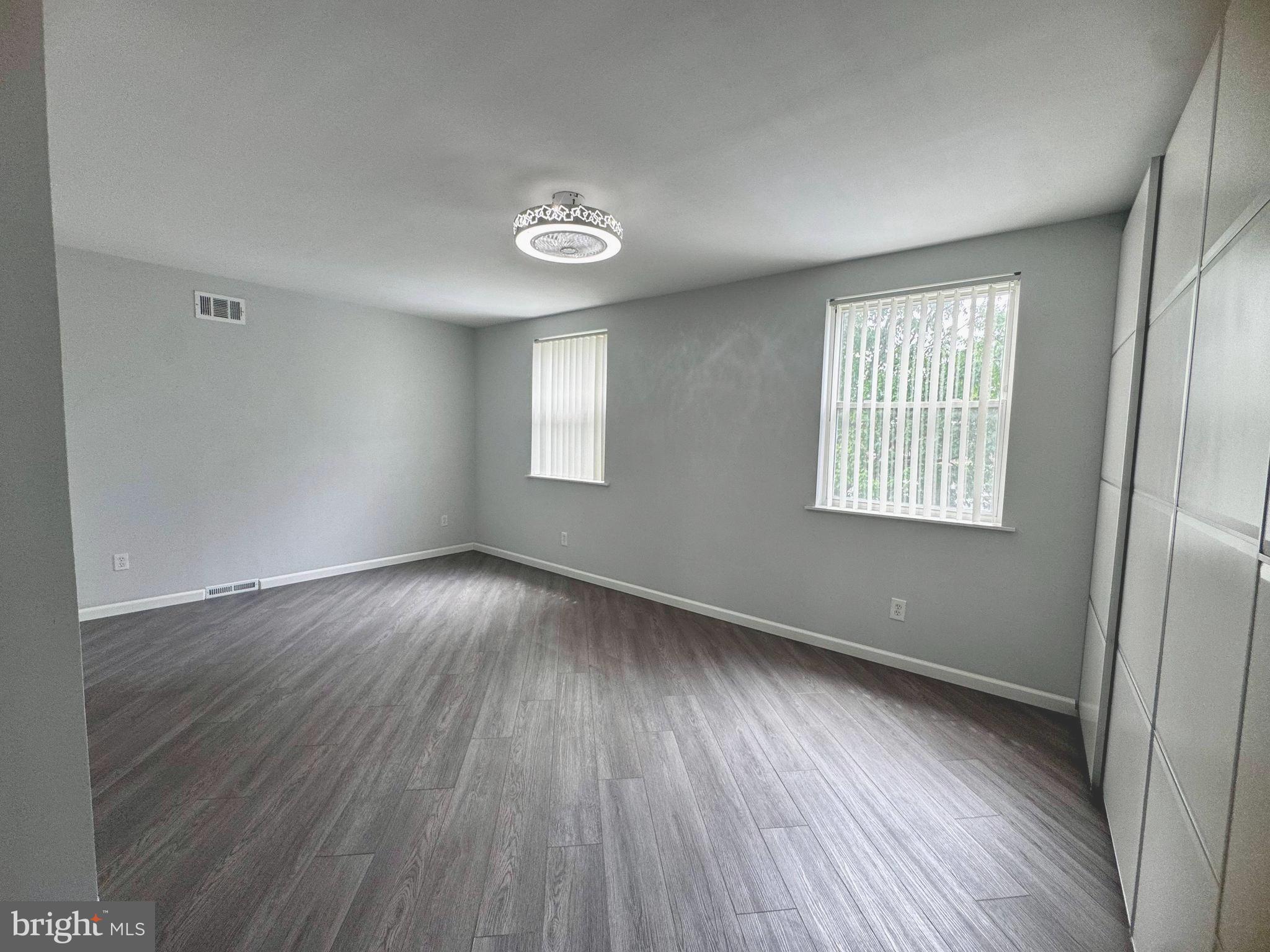 3627 Newberry Road Philadelphia, PA 19154 - Photo 12 of 28 an empty room with wooden floor and windows