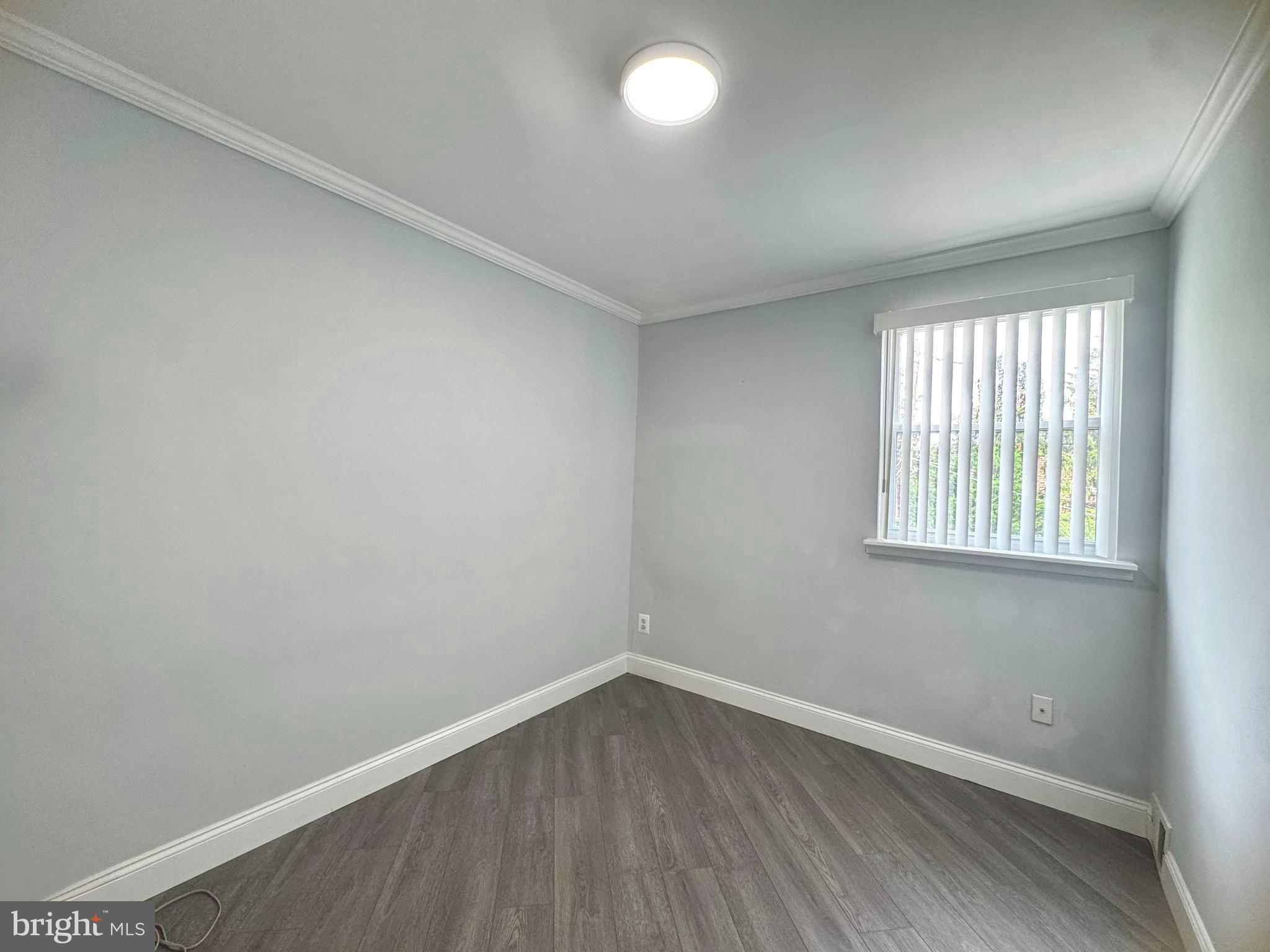 3627 Newberry Road Philadelphia, PA 19154 - Photo 16 of 28 an empty room with wooden floor and windows
