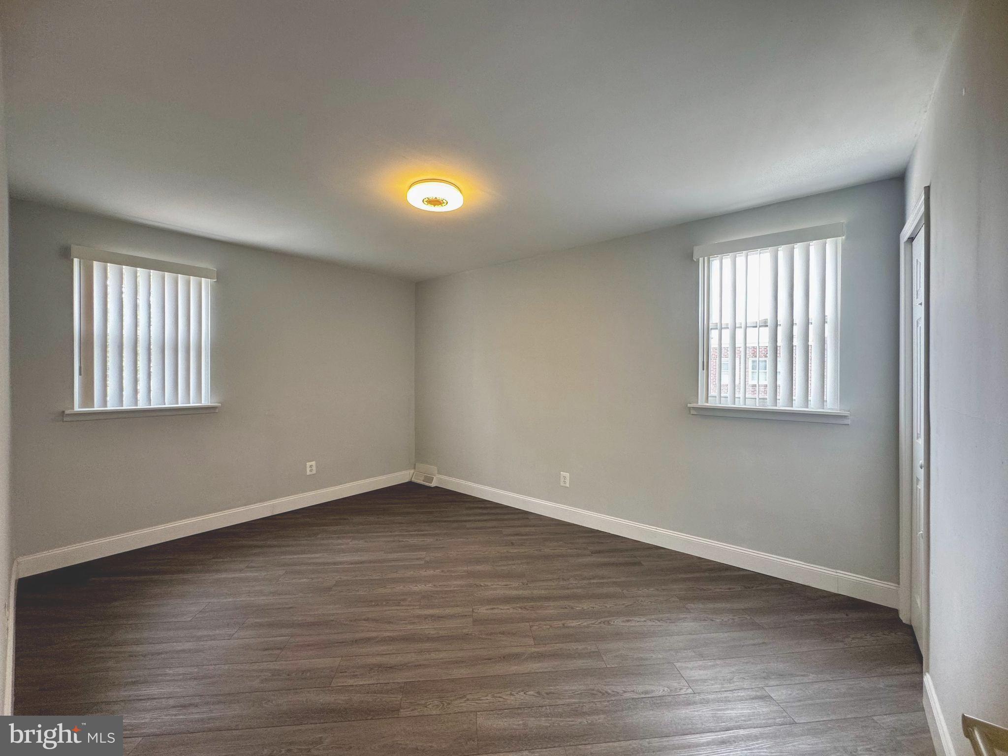3627 Newberry Road Philadelphia, PA 19154 - Photo 17 of 28 an empty room with wooden floor and windows