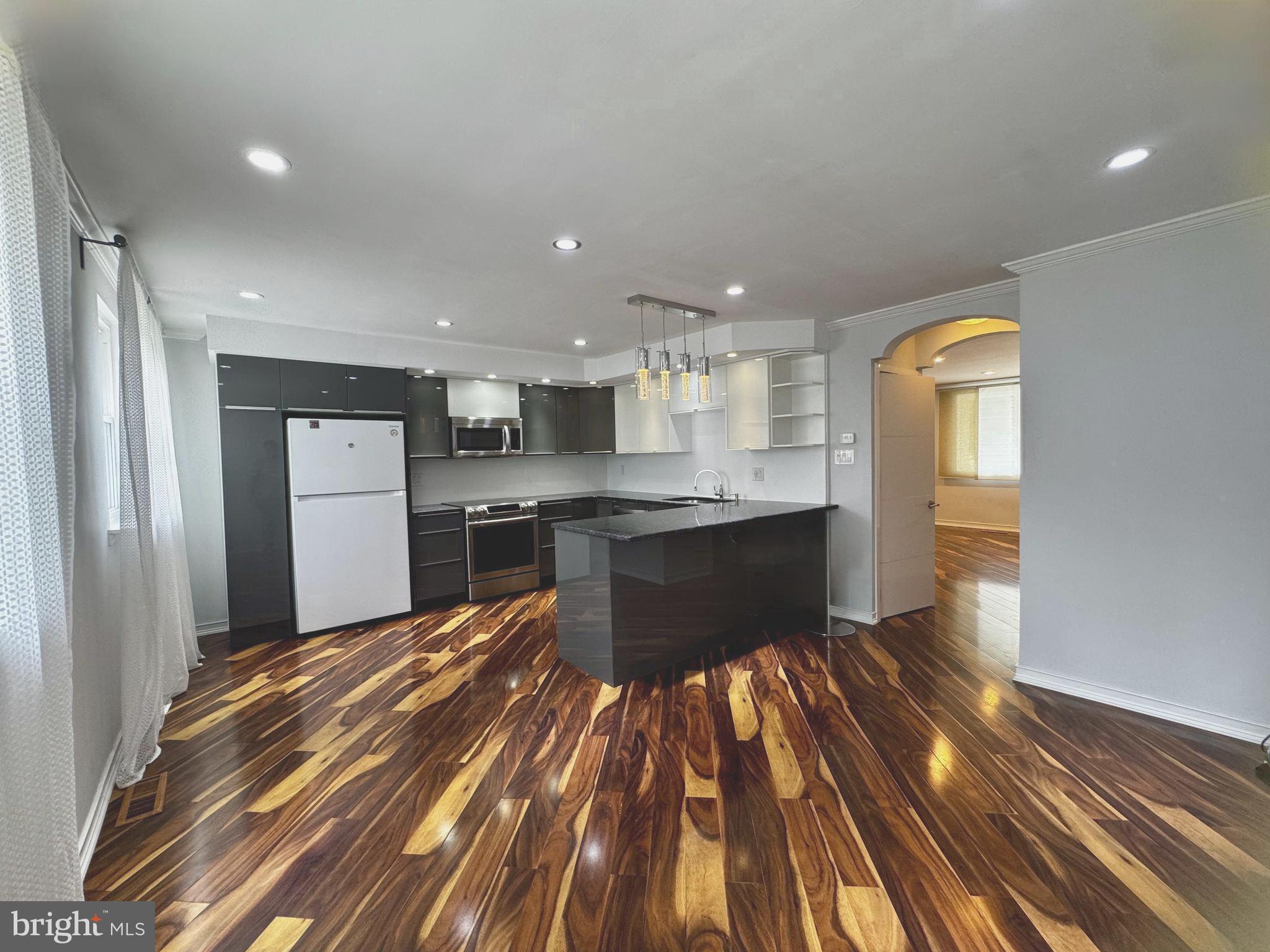 3627 Newberry Road Philadelphia, PA 19154 - Photo 3 of 28 a kitchen with a refrigerator and wooden floor