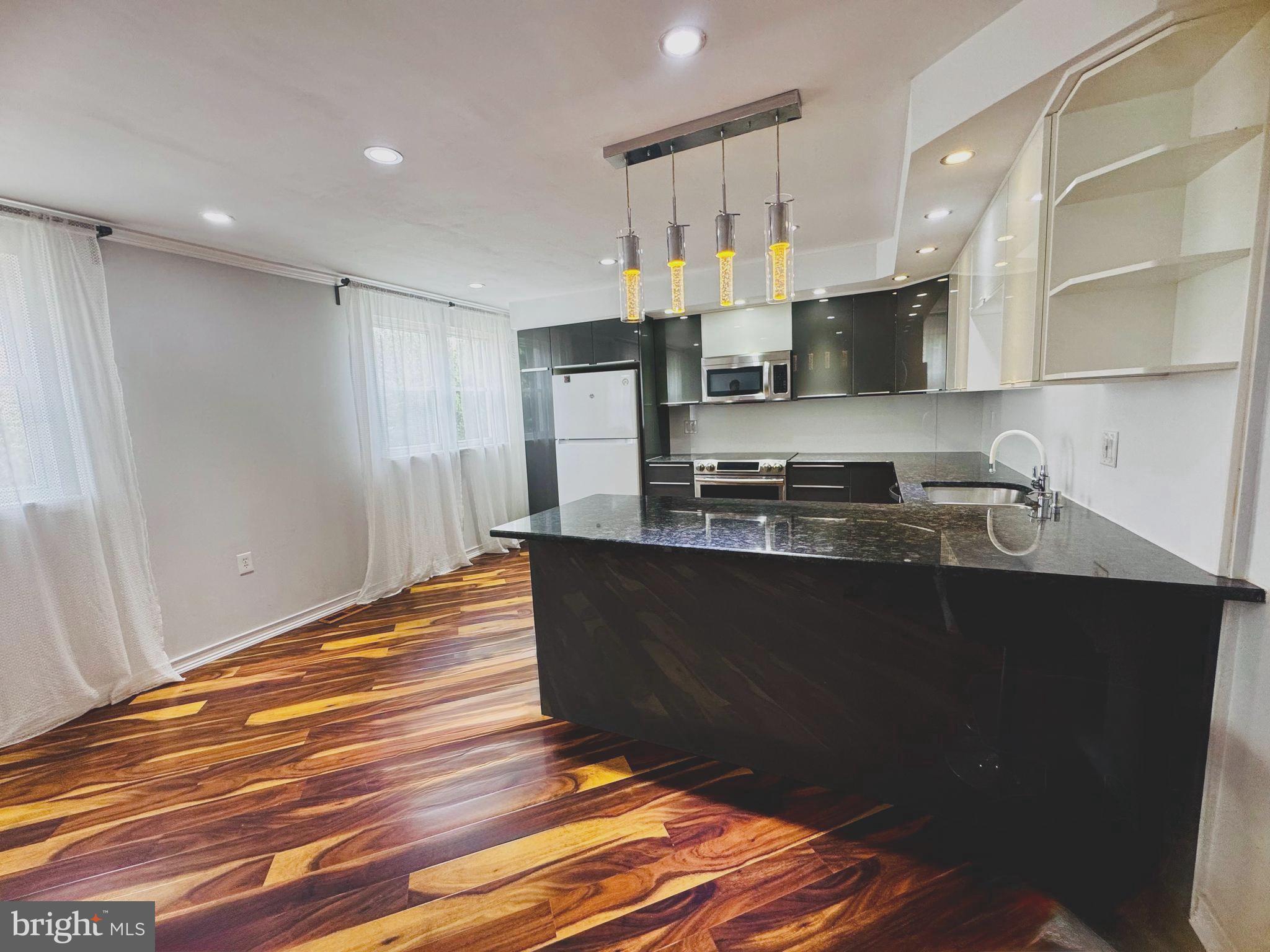 3627 Newberry Road Philadelphia, PA 19154 - Photo 4 of 28 a kitchen with granite countertop a refrigerator and a stove top oven
