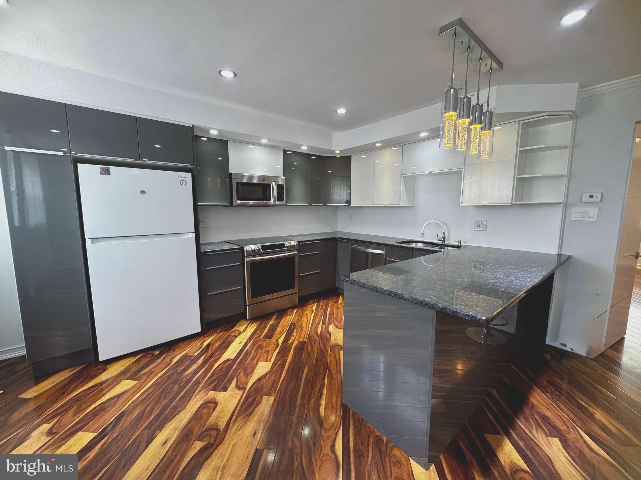 3627 Newberry Road Philadelphia, PA 19154 - Photo 5 of 28 a kitchen with a sink a refrigerator and a stove top oven