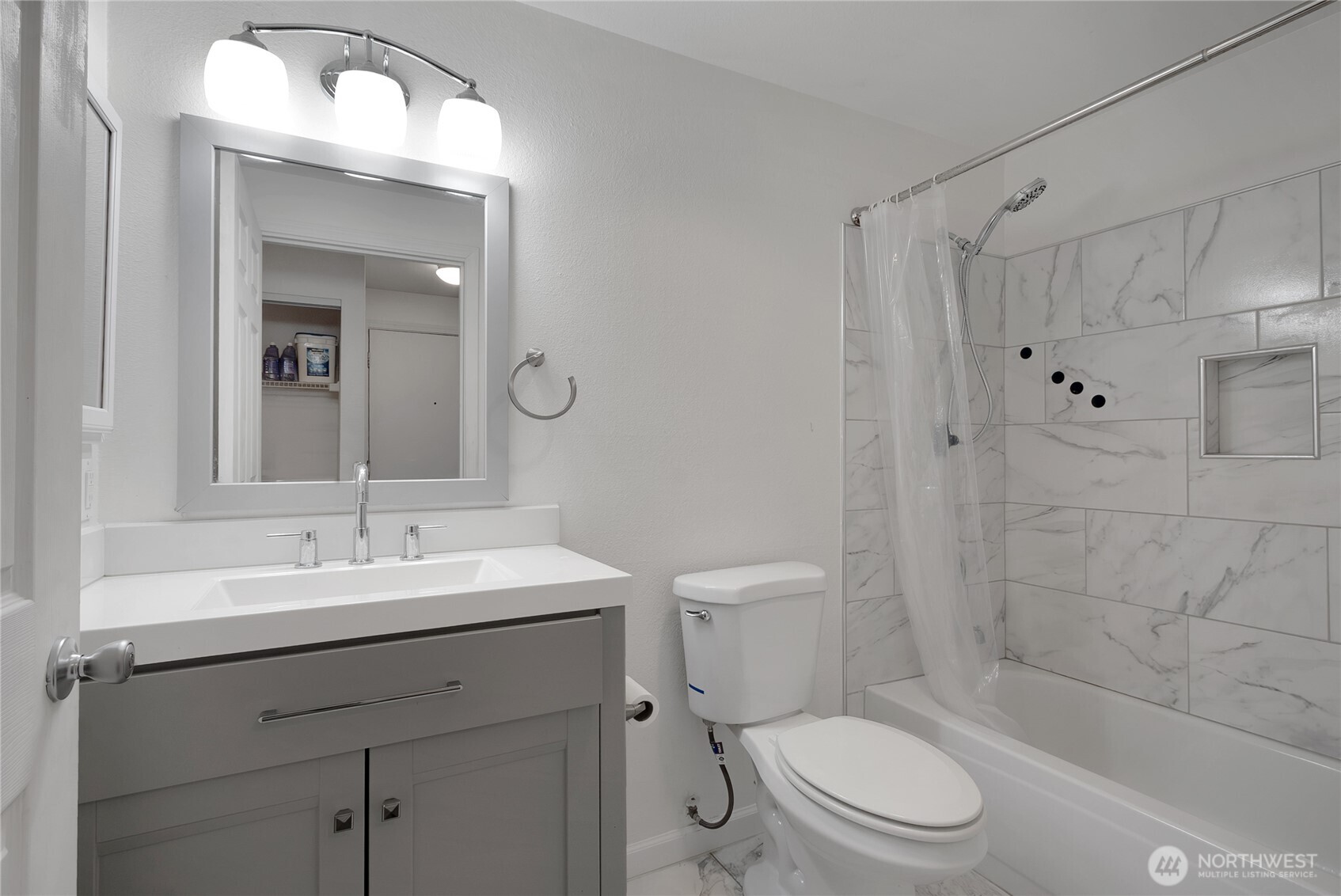 11002 Southeast Petrovitsky Road, Unit E103 Renton, WA 98055 - Photo 8 of 14 a bathroom with a sink a toilet and shower