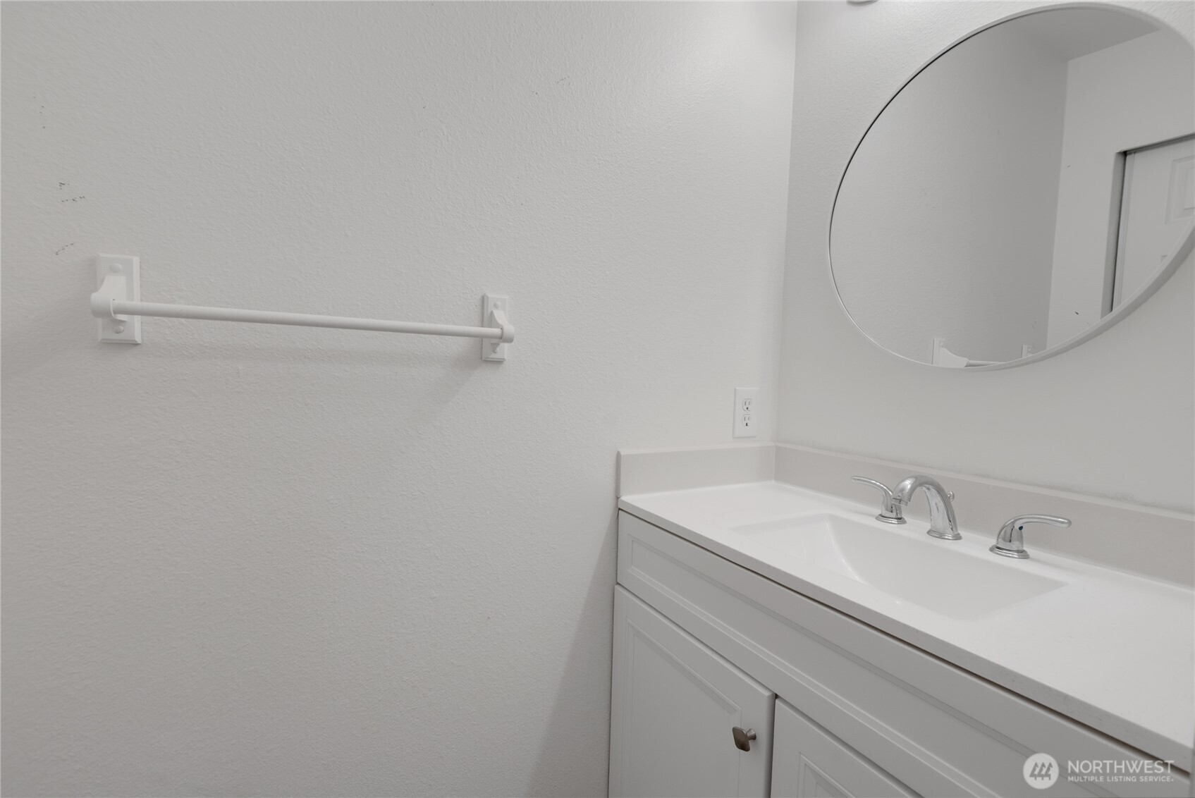 11002 Southeast Petrovitsky Road, Unit E103 Renton, WA 98055 - Photo 9 of 14 a bathroom with a sink and a mirror