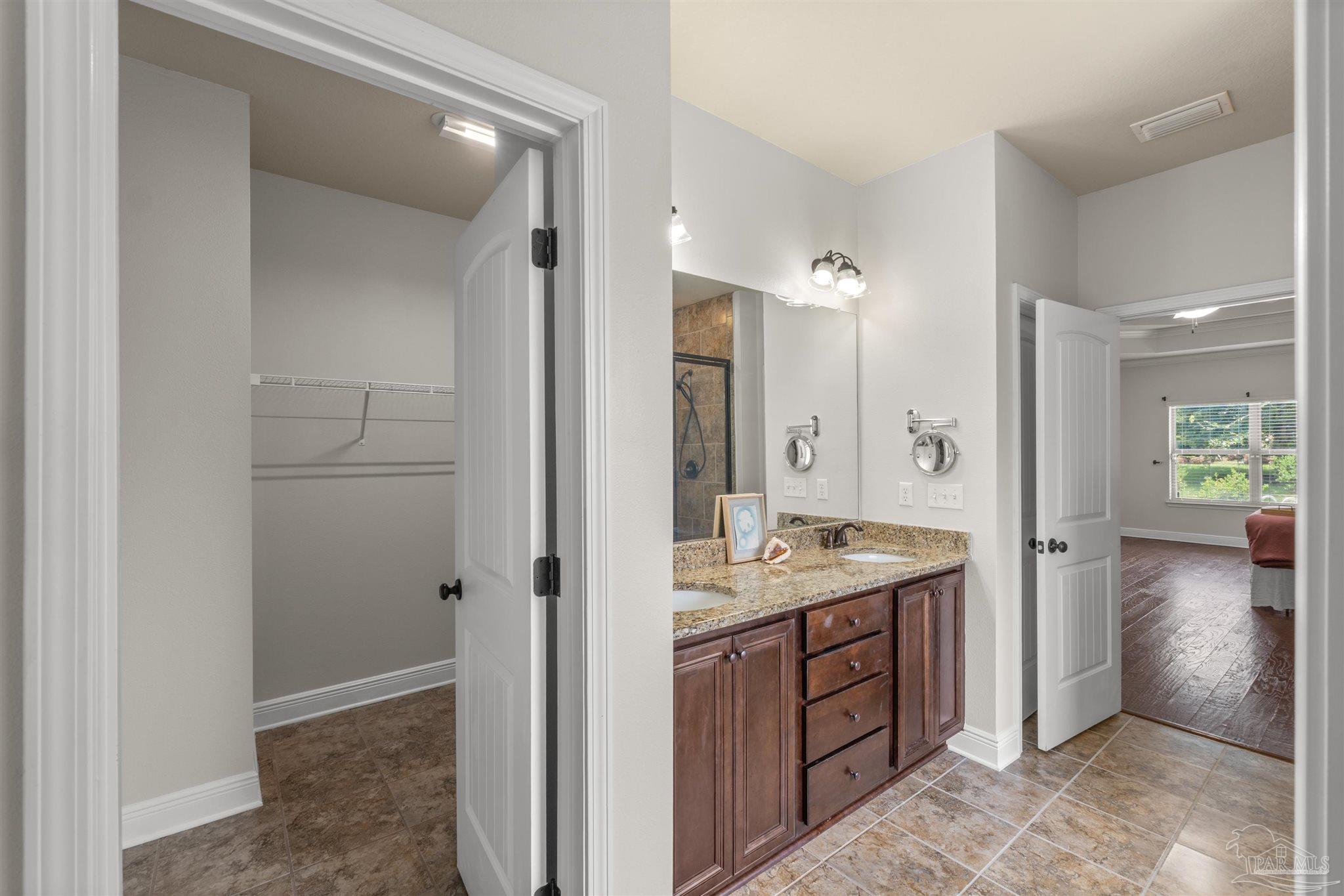 2698 Tulip Hill Road Pace, FL 32571 - Photo 43 of 65 a spacious bathroom with a granite countertop sink a mirror and a