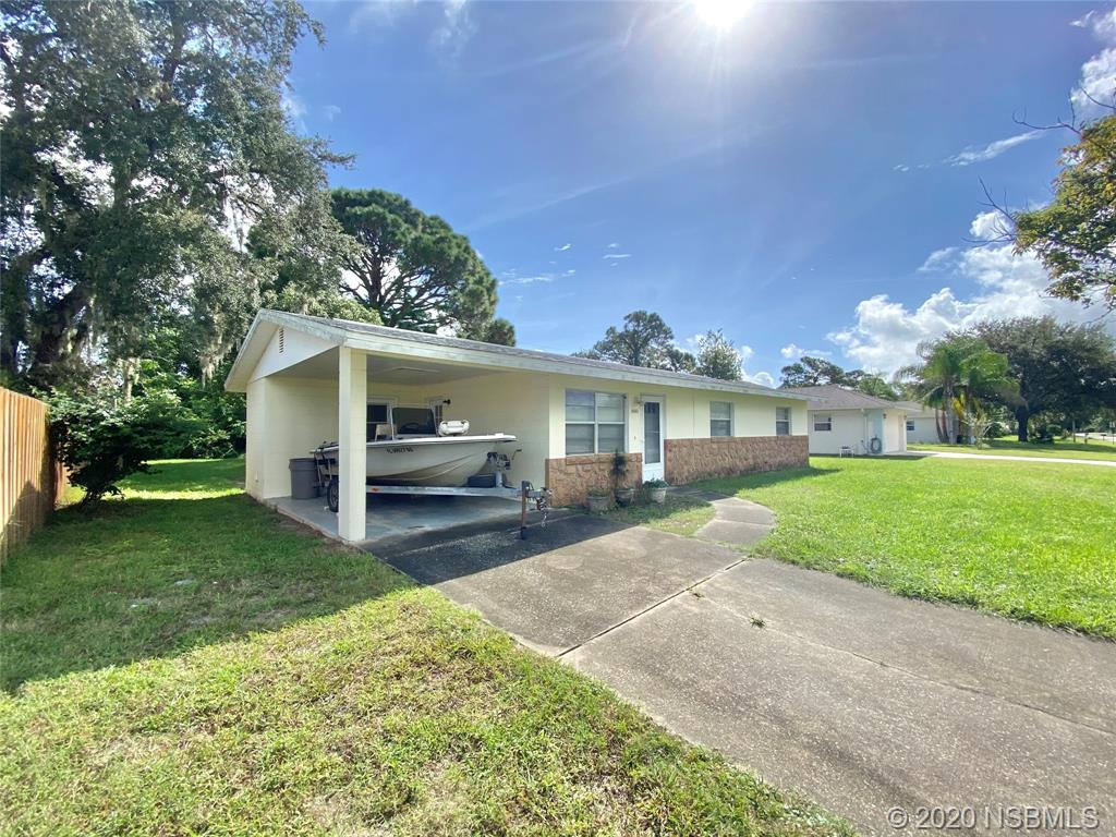 1423 Victory Palm Drive Edgewater, FL 32132 - Photo 2 of 11 a front view of a house with garden