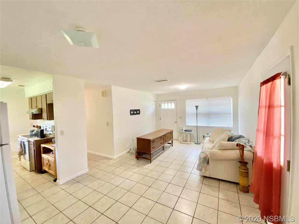 1423 Victory Palm Drive Edgewater, FL 32132 - Photo 5 of 11 a living room with furniture and a flat screen tv
