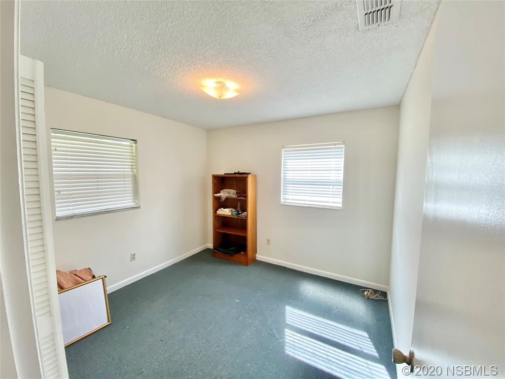 1423 Victory Palm Drive Edgewater, FL 32132 - Photo 7 of 11 an empty room with windows