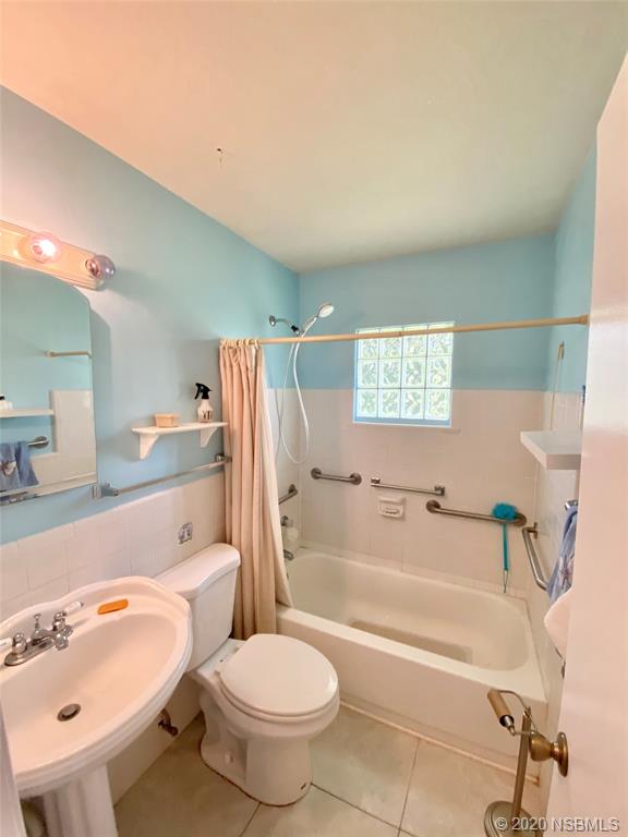 1423 Victory Palm Drive Edgewater, FL 32132 - Photo 9 of 11 a bathroom with a sink a toilet and a bathtub