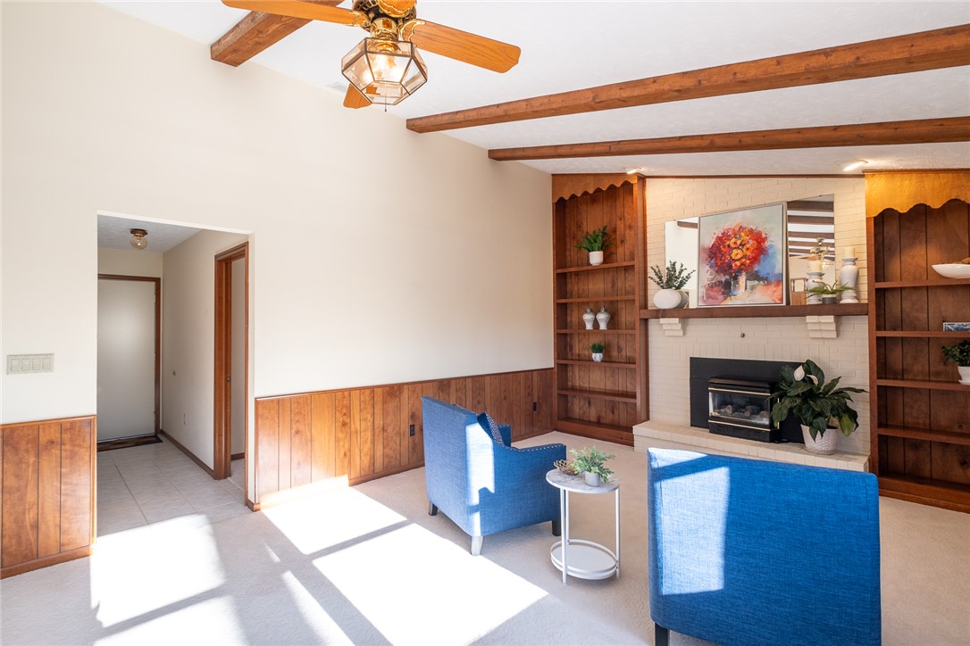 276 South Fairfield Road Bellbrook, OH 45305 - Photo 14 of 38 This inviting living space features warm wood accents and a cozy fireplace, perfect for relaxation.