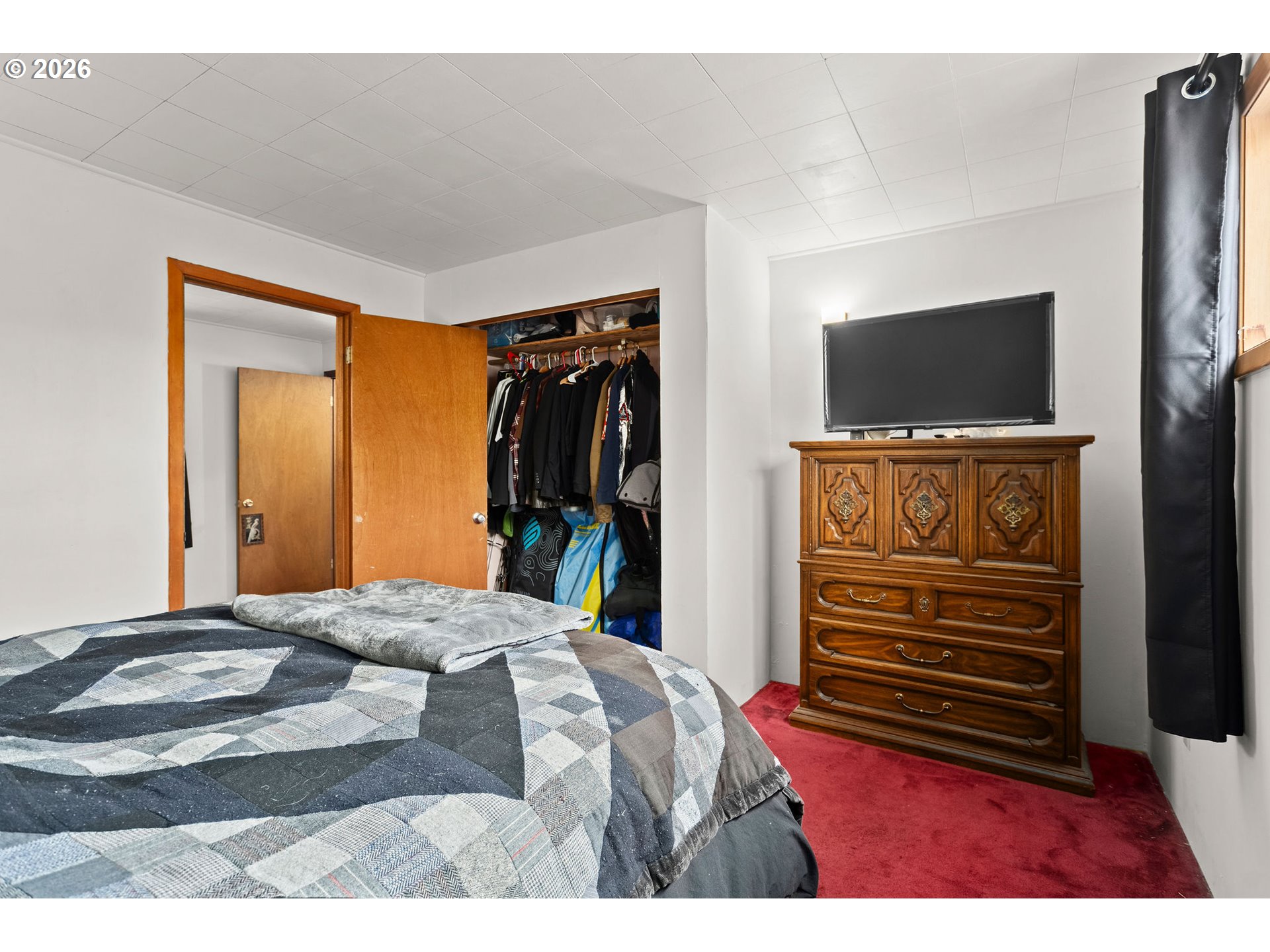 472 Northwest Hot Springs Alameda Road Stevenson, WA 98648 - Photo 47 of 48 a bedroom with a bed and a flat screen tv