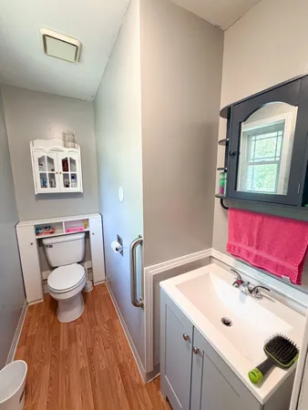 a bathroom with a toilet sink and mirror