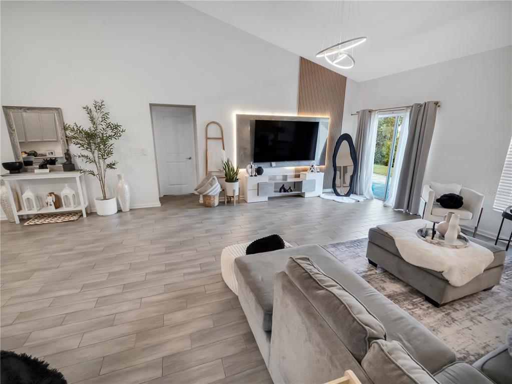 771 Hitch Loop St. Cloud, FL 34772 - Photo 12 of 34 a living room with furniture and a flat screen tv