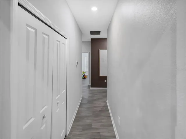 a view of a hallway with a wooden door