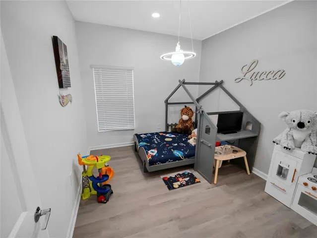 a bedroom with furniture and a flat screen tv