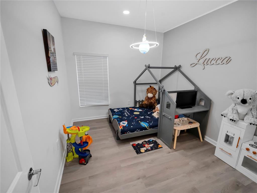 771 Hitch Loop St. Cloud, FL 34772 - Photo 17 of 34 a bedroom with furniture and a flat screen tv