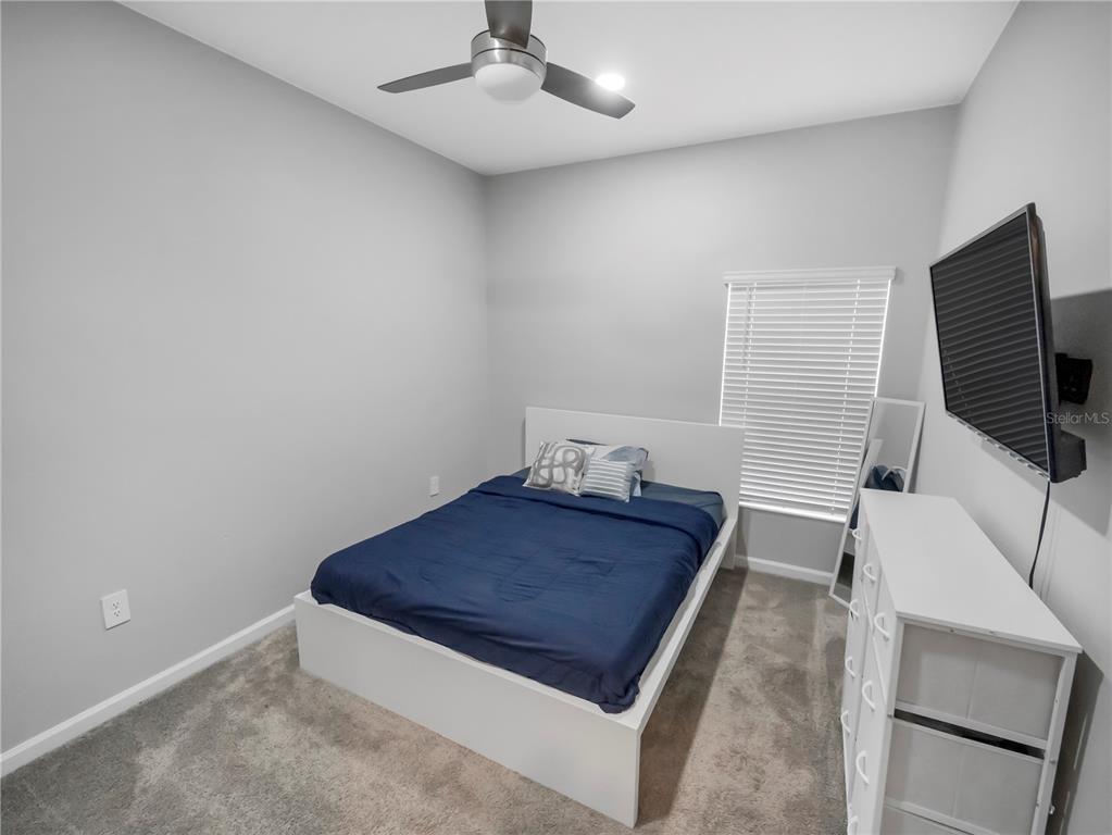 771 Hitch Loop St. Cloud, FL 34772 - Photo 18 of 34 a living room with furniture and a flat screen tv