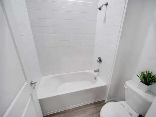 a white bath tub sitting next to a white toilet