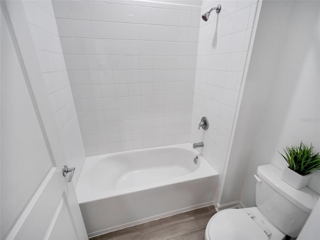 771 Hitch Loop St. Cloud, FL 34772 - Photo 21 of 34 a white bath tub sitting next to a white toilet