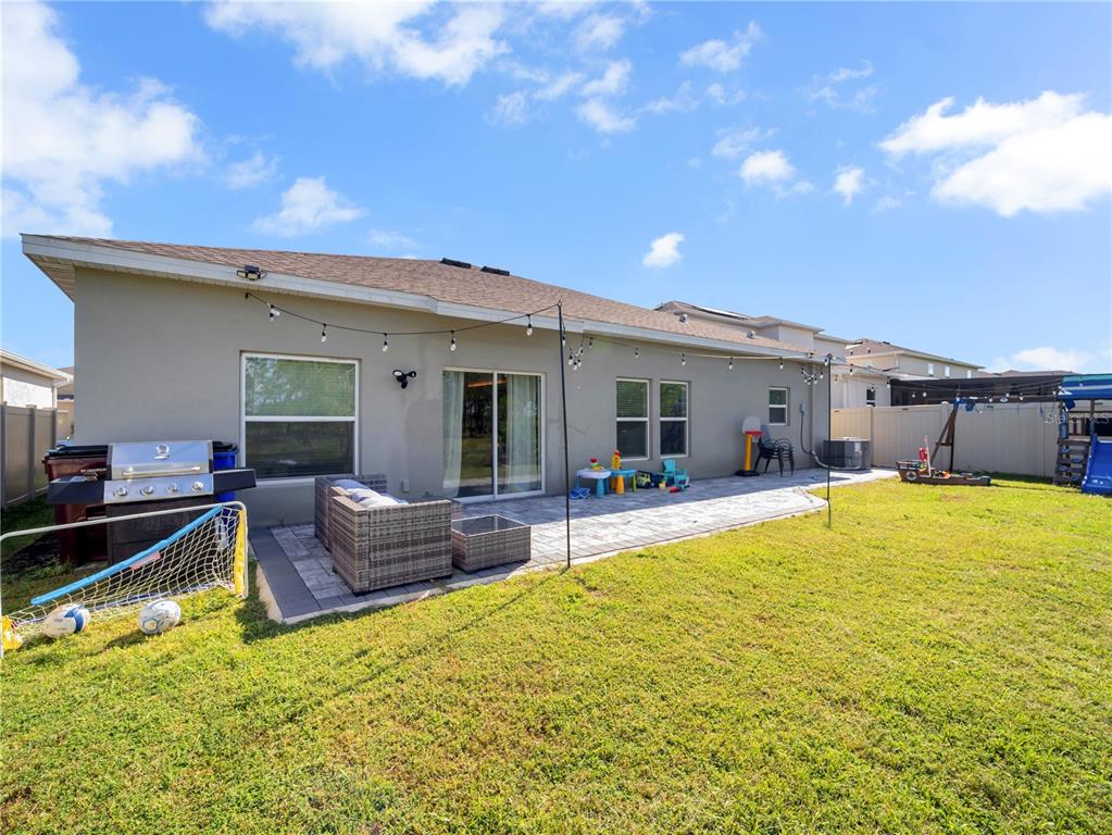 771 Hitch Loop St. Cloud, FL 34772 - Photo 26 of 34 a view of a house with swimming pool and a yard