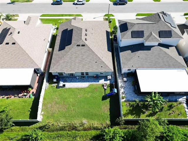 an aerial view of a house with a yard