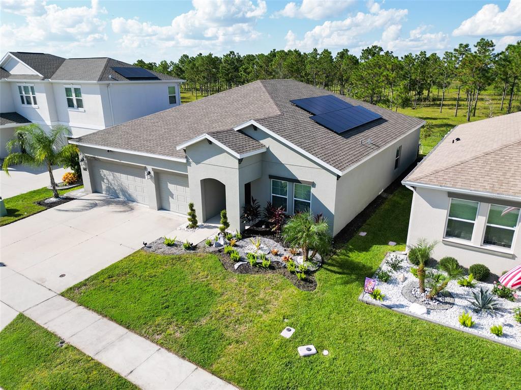 771 Hitch Loop St. Cloud, FL 34772 - Photo 3 of 34 a aerial view of a house with table and chairs in a garden