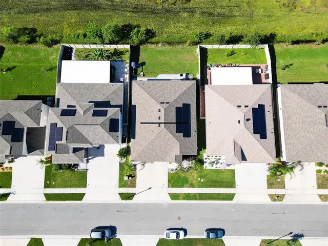 an aerial view of multiple houses with outdoor space