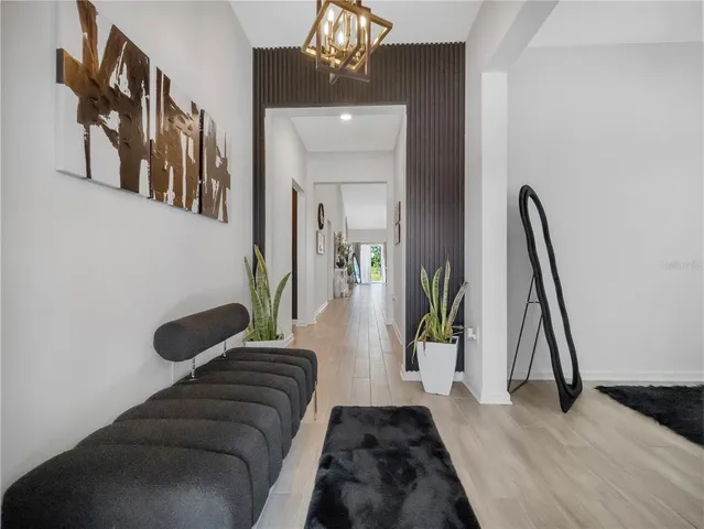 a living room with furniture and a ceiling fan