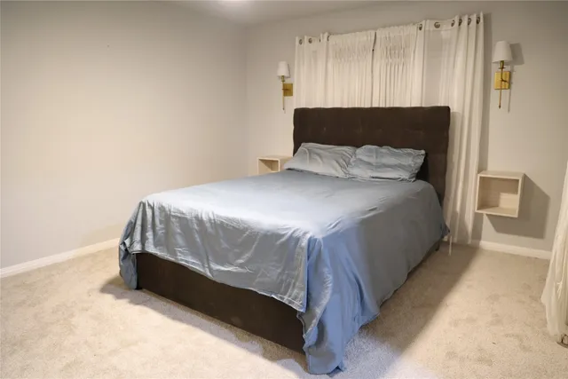 a bedroom with a bed and a night stand