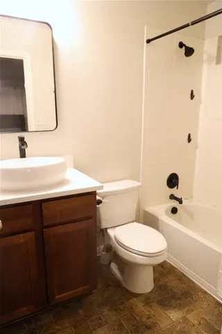 a bathroom with a sink toilet vanity and shower