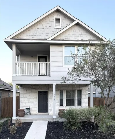 a front view of a house with a garden and entryway