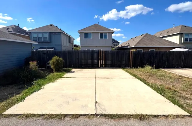 a view of a house with a backyard