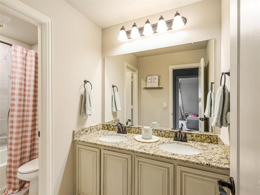 1216 Tree Shadow Lane Anna, TX 75409 - Photo 29 of 37 a bathroom with a granite countertop sink and a mirror