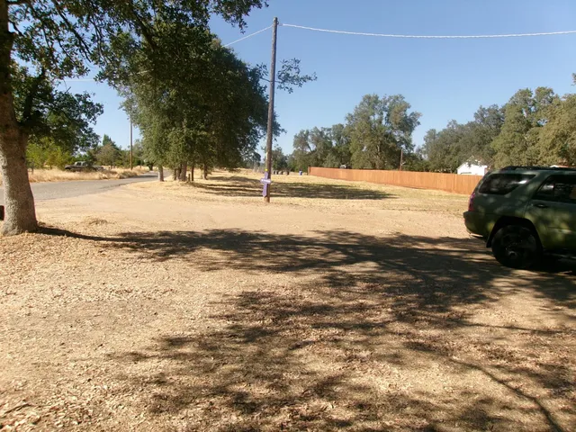 a view of a house with a yard covered in snow
