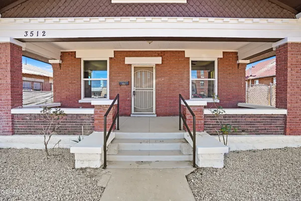 front view of a house with a bench