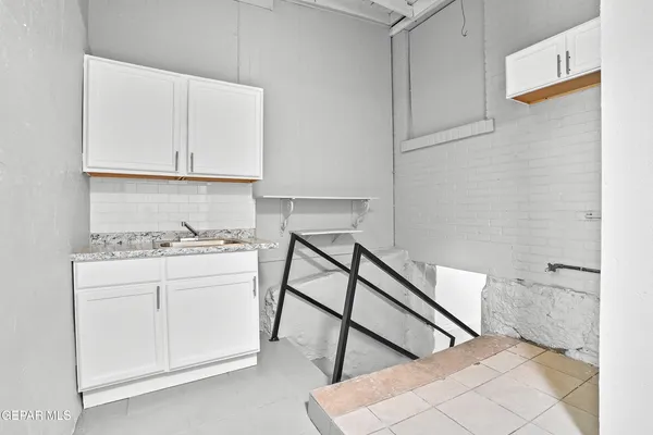 a kitchen with a cabinets and a stove top oven