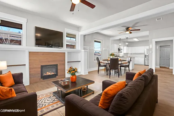 a living room with furniture fireplace and flat screen tv