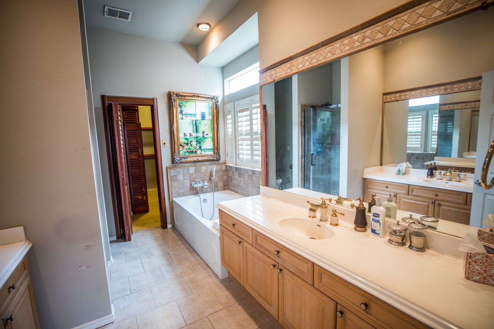 2918 Ranch Road 620 North, Unit 270 Austin, TX 78734 - Photo 24 of 34 a bathroom with a double vanity sink a mirror and a shower