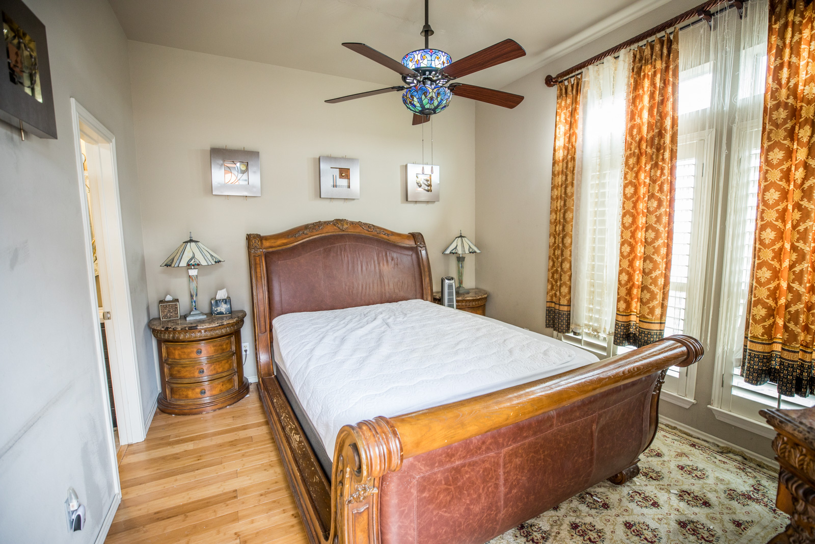 2918 Ranch Road 620 North, Unit 270 Austin, TX 78734 - Photo 28 of 34 a bedroom with a bed and wooden floor