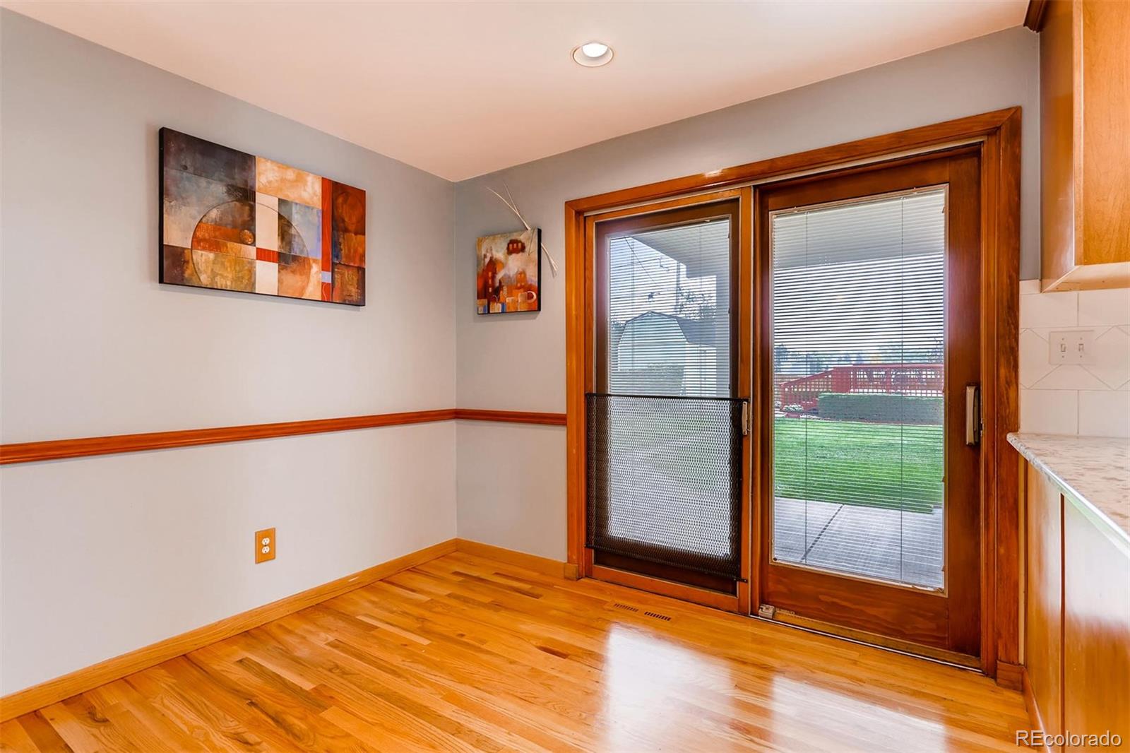 1458 South Oneida Street Denver, CO 80224 - Photo 13 of 33 a view of an empty room with wooden floor and a window