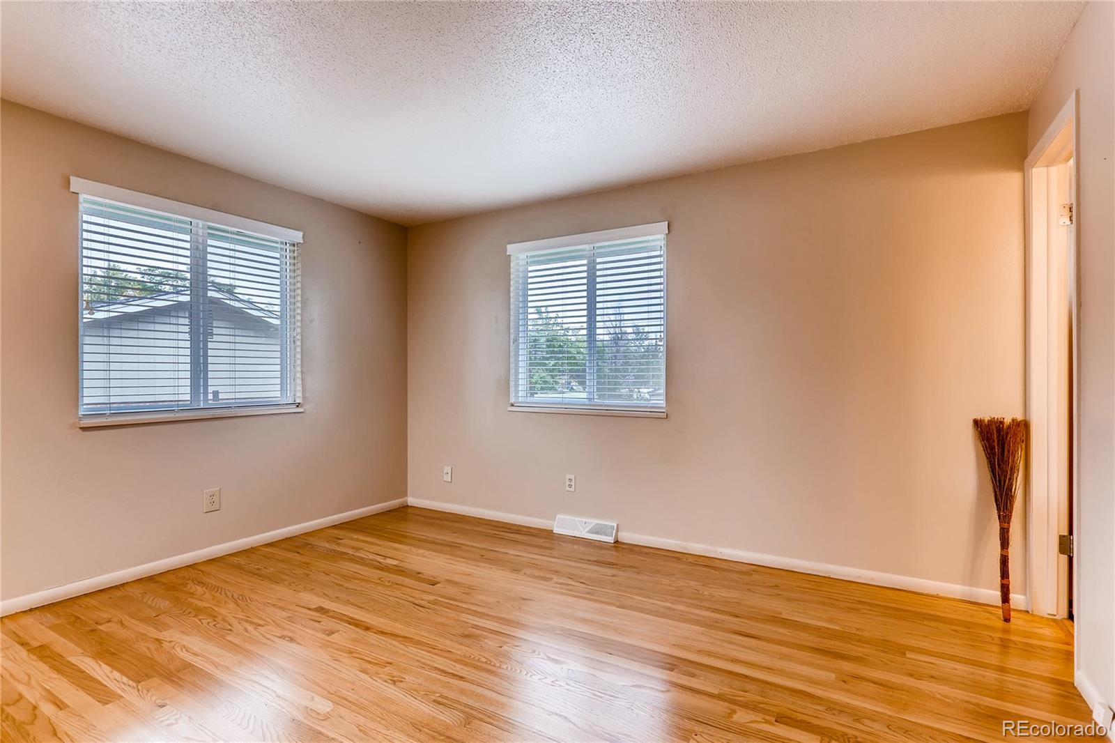 1458 South Oneida Street Denver, CO 80224 - Photo 14 of 33 a view of a room with wooden floor and windows
